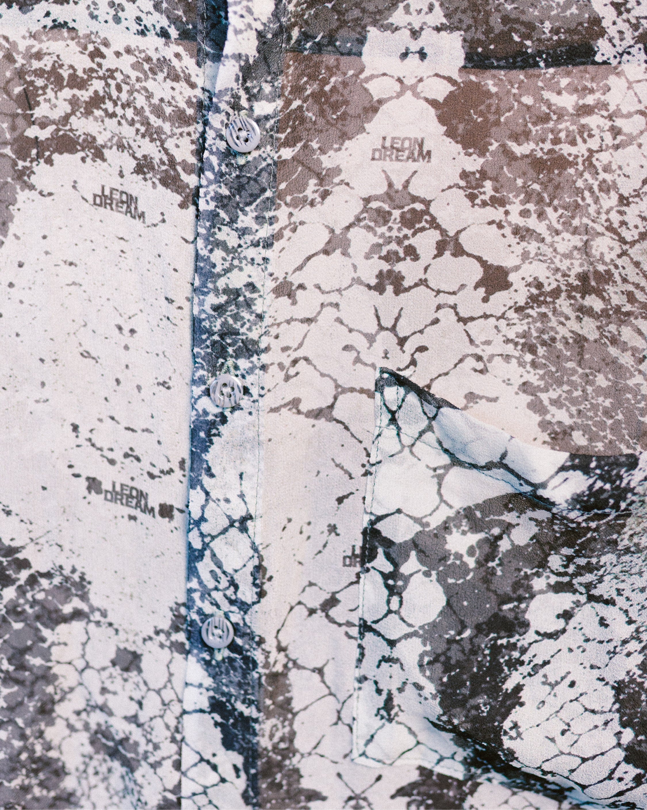 Close-up shot of the patterns of the Green Ophidian silk chiffon shirt by Leon Dream