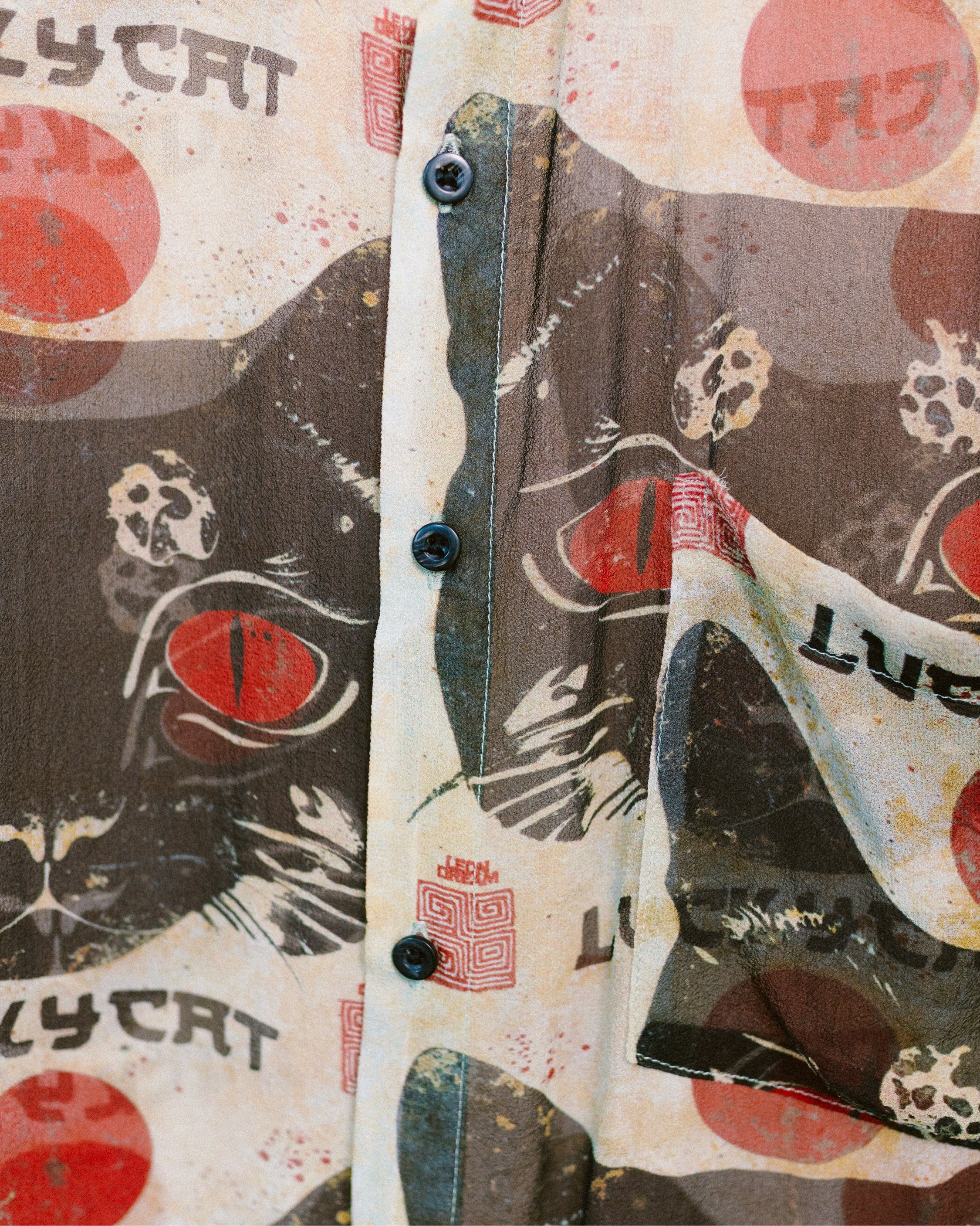 Close-up shot of the patterns on the Lucky Cat shirt by Leon Dream